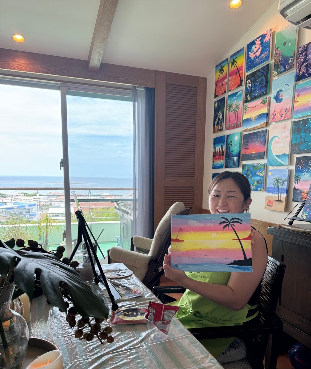 Pinto Beetle guest smiling with a finished pink wave sunset painting